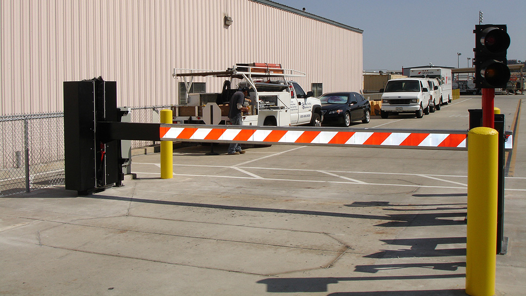 Barrier arm gate controlling vehicle access at a commercial parking lot entrance