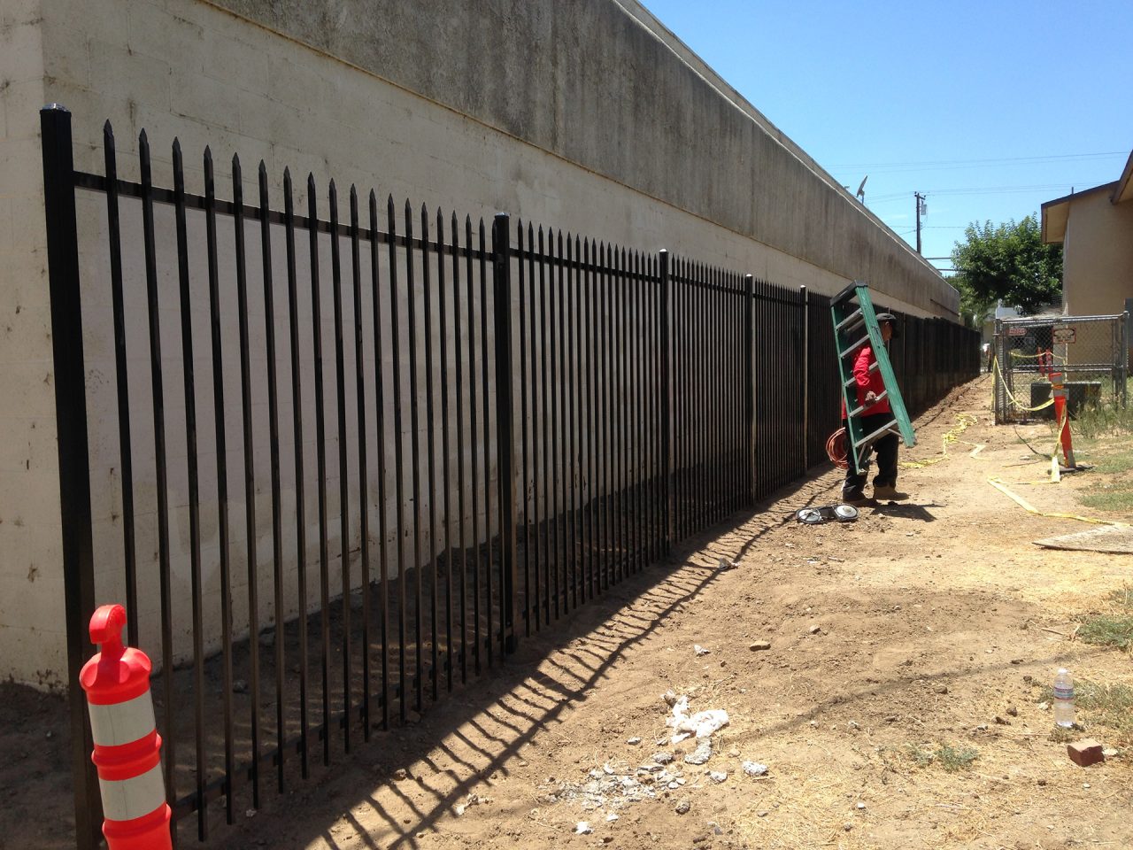 Black wrought iron security fencing installation by Lobby Traffic Systems