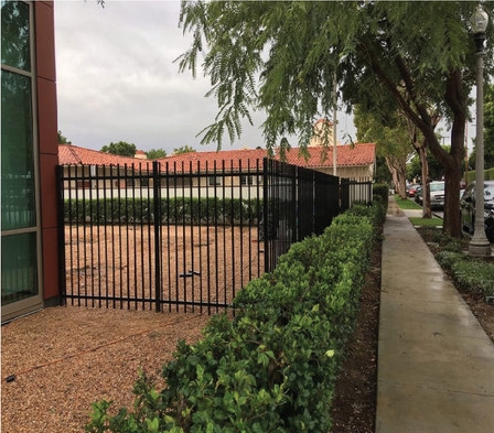Wrought-iron perimeter fencing along a commercial property